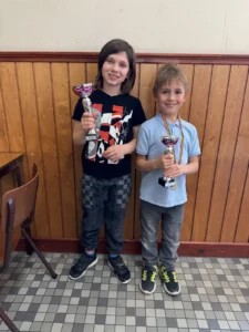Miro Ok holding a chess tournament trophy